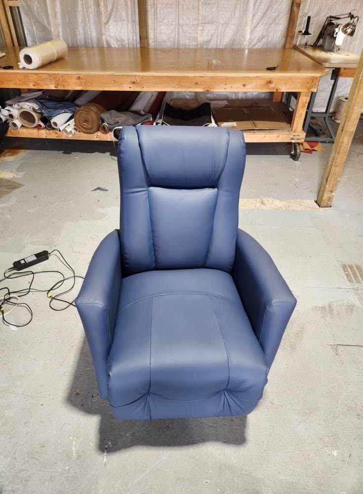Le même fauteuil inclinable recouvert d'un revêtement bleu marine neuf, après le rembourrage
